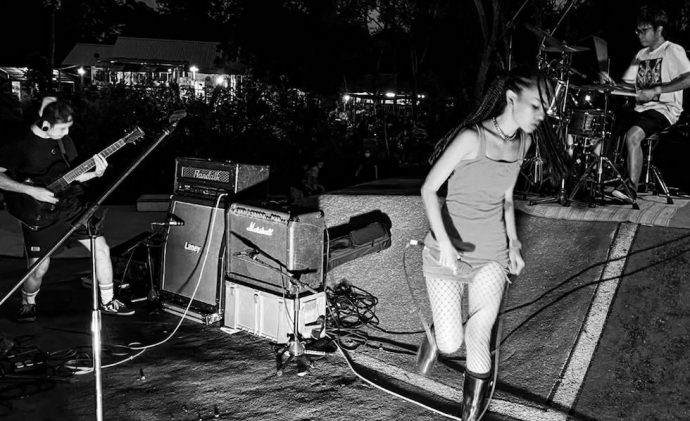 Black and white photo of Speech Odd performing live at night in a skatepark