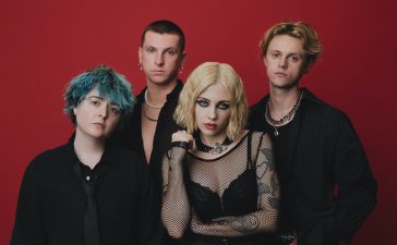Pale Waves artist photo featuring the band members in front of a red backdrop